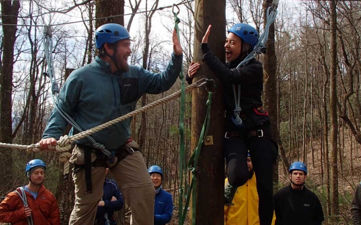 adults learn rock climbing skills in blue ridge mountains